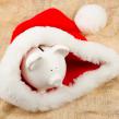 holiday bills, piggy bank in a santa hat
